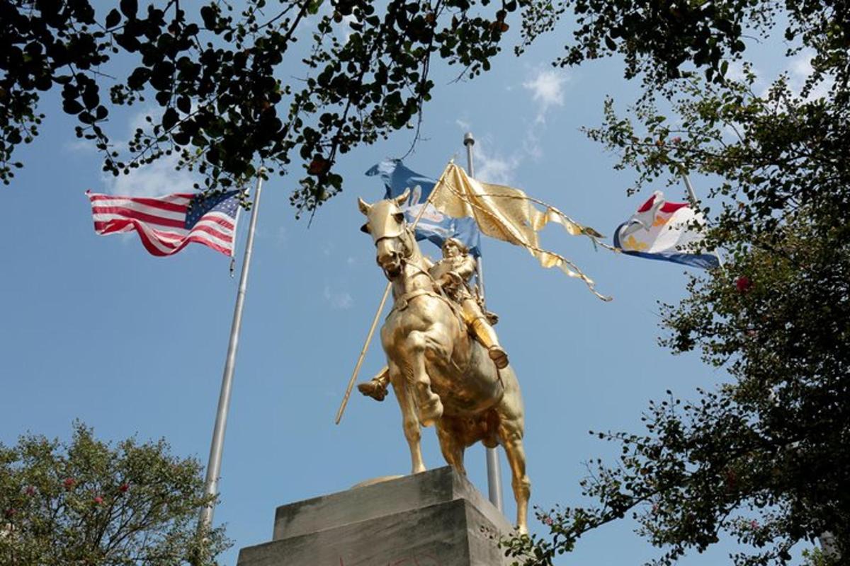 a statue of a man on a horse and flags
