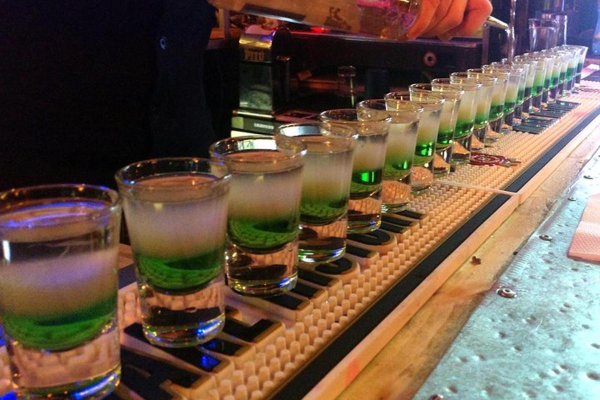 a row of glasses of beer on a bar