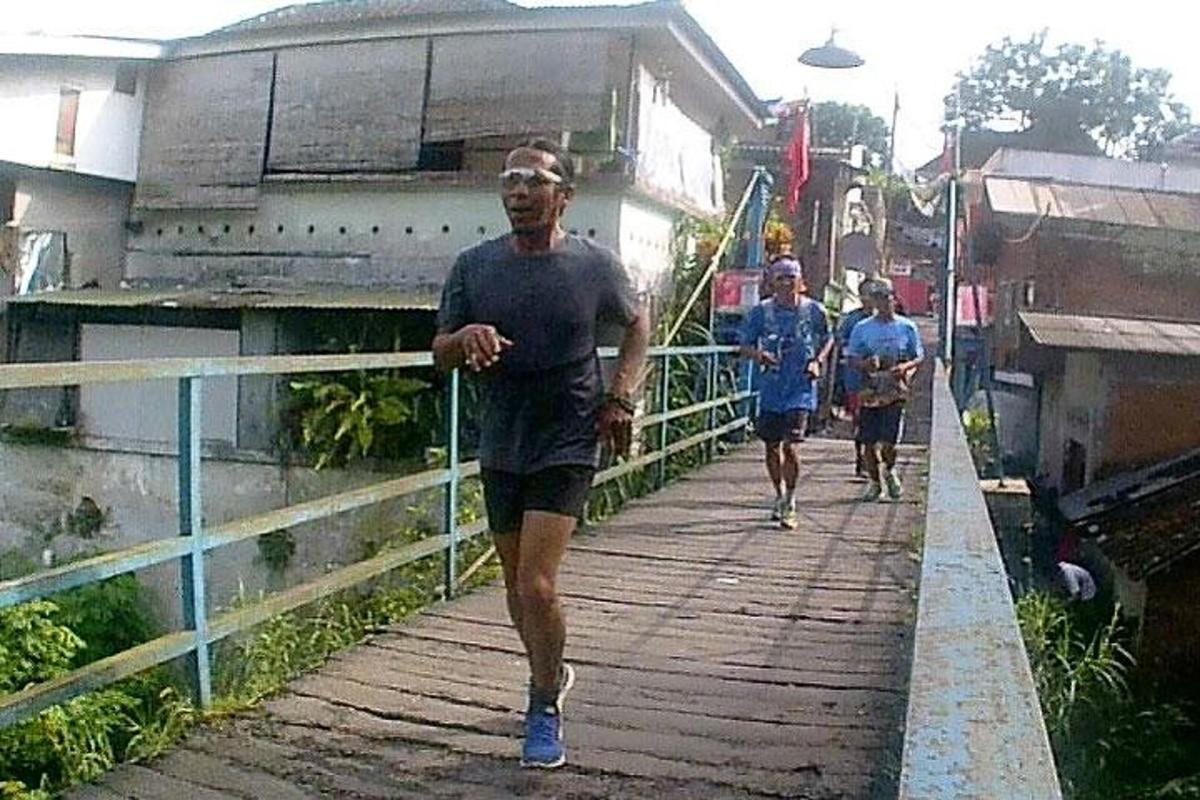 a group of people running on a bridge