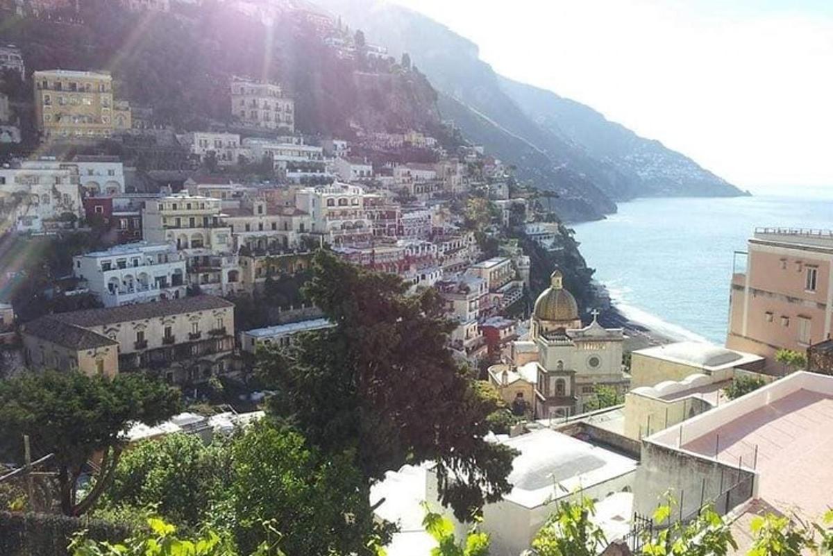 a group of buildings on a hill next to the ocean