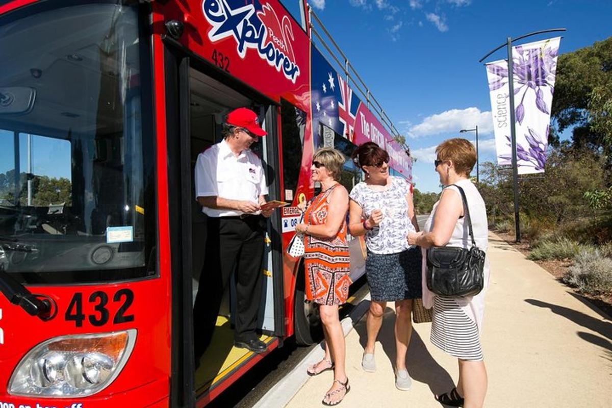 a group of people getting on a red bus