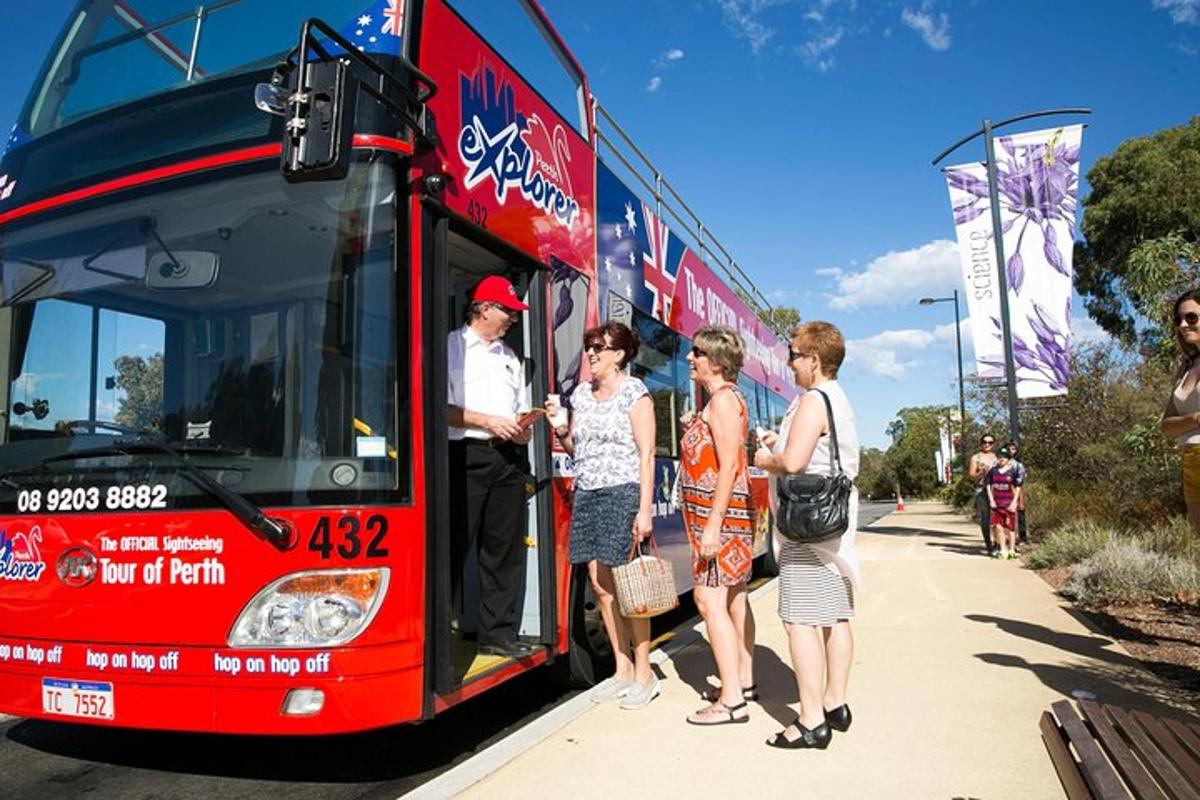 a group of people standing outside of a bus