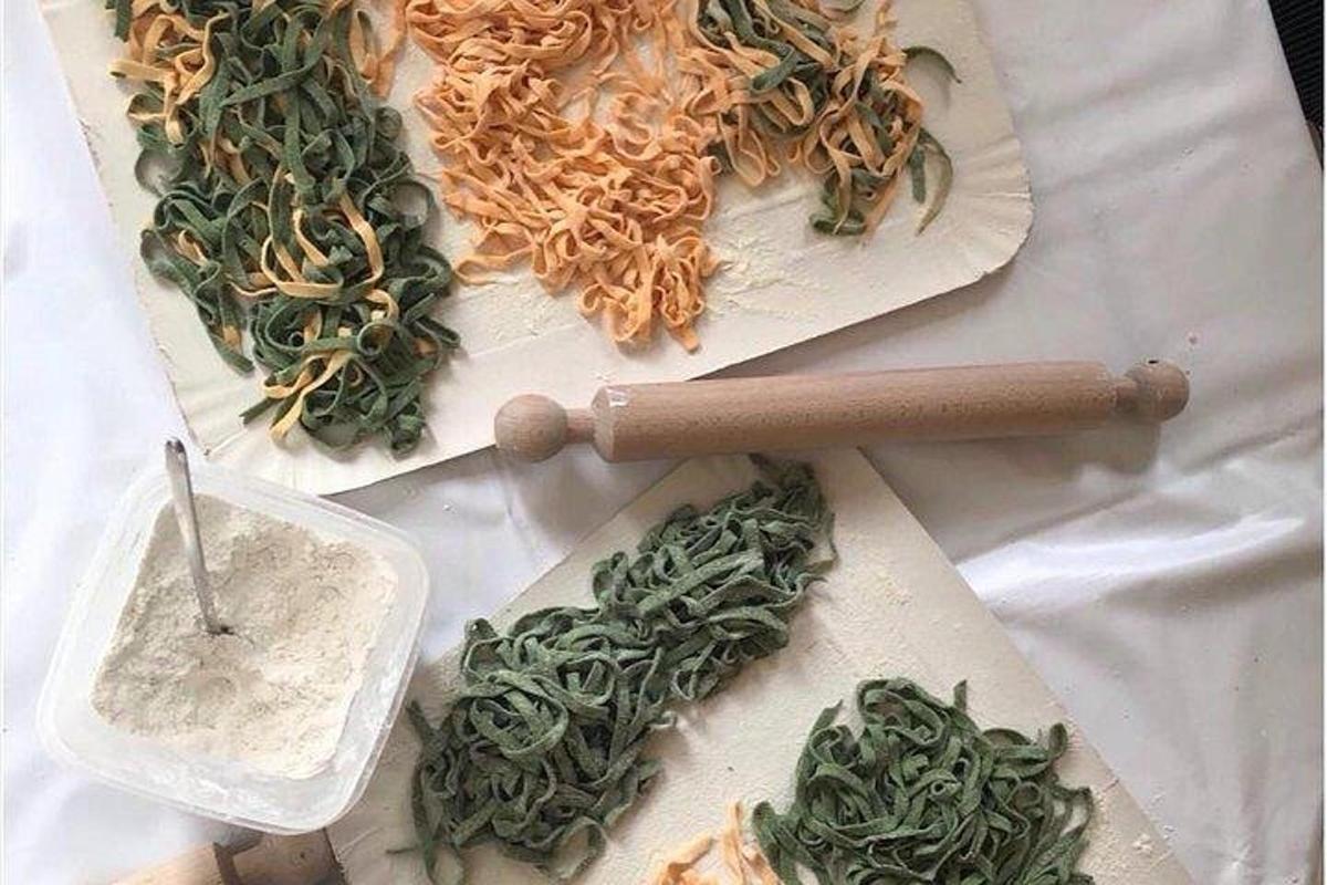 a table topped with different types of noodles and vegetables