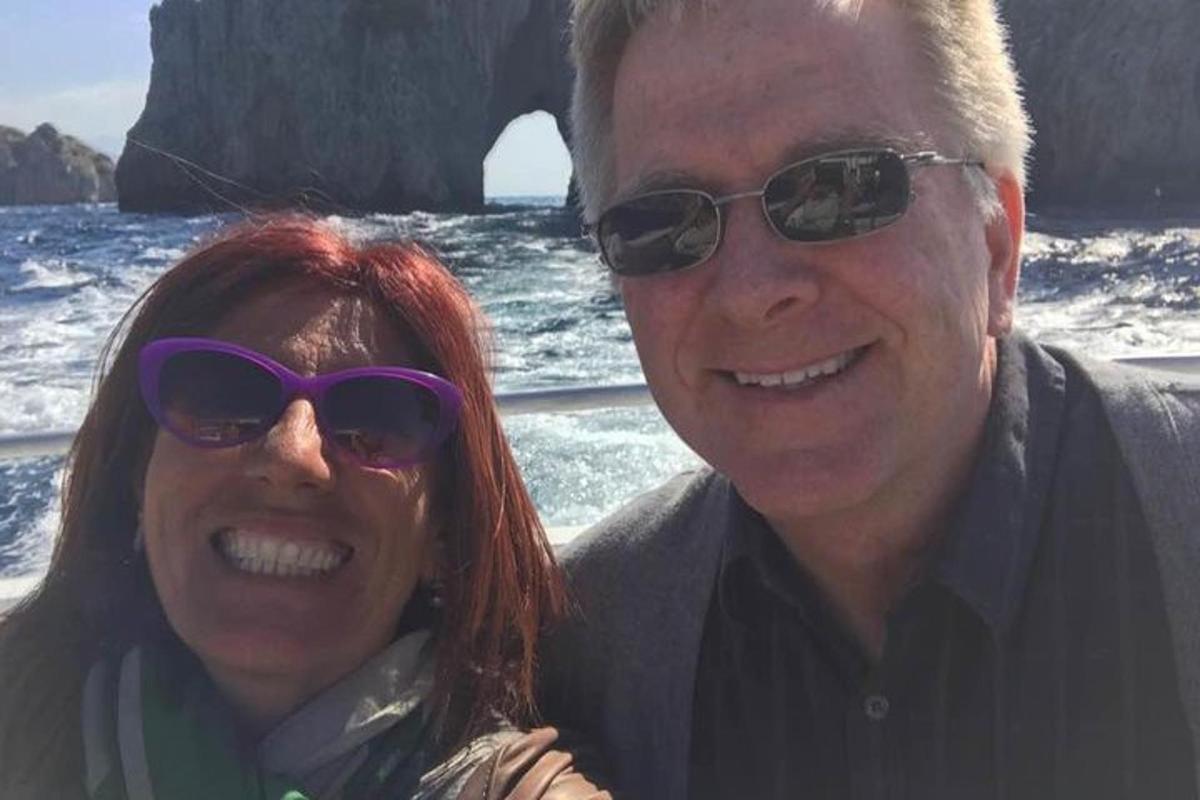 a man and a woman in sunglasses on a boat