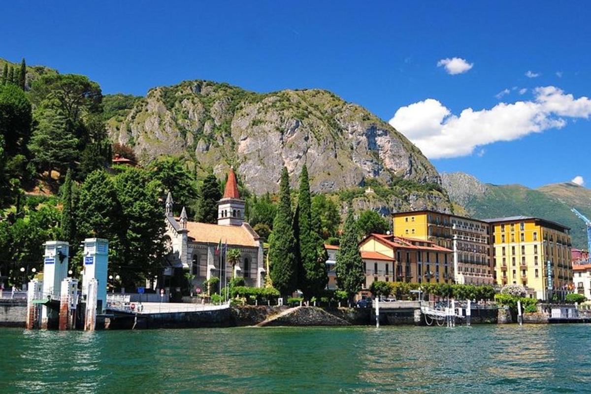a town on the water in front of a mountain