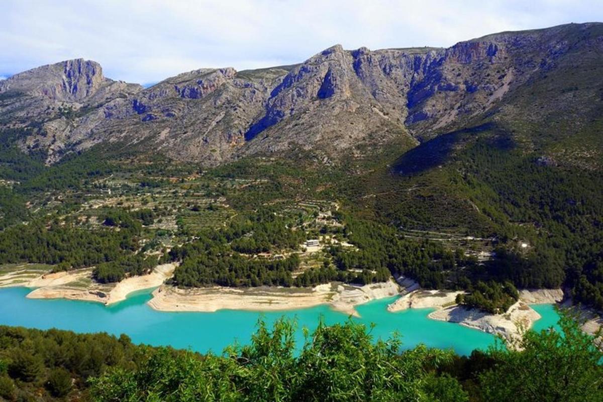 an aerial view of a lake in the mountains