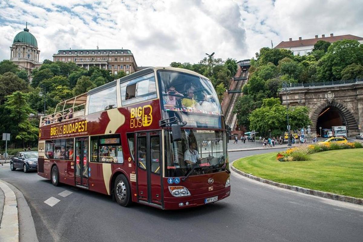 a red double decker bus driving down a street