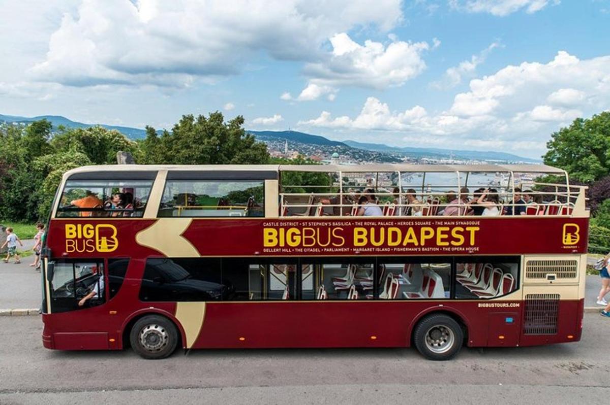 a red double decker bus driving down a street