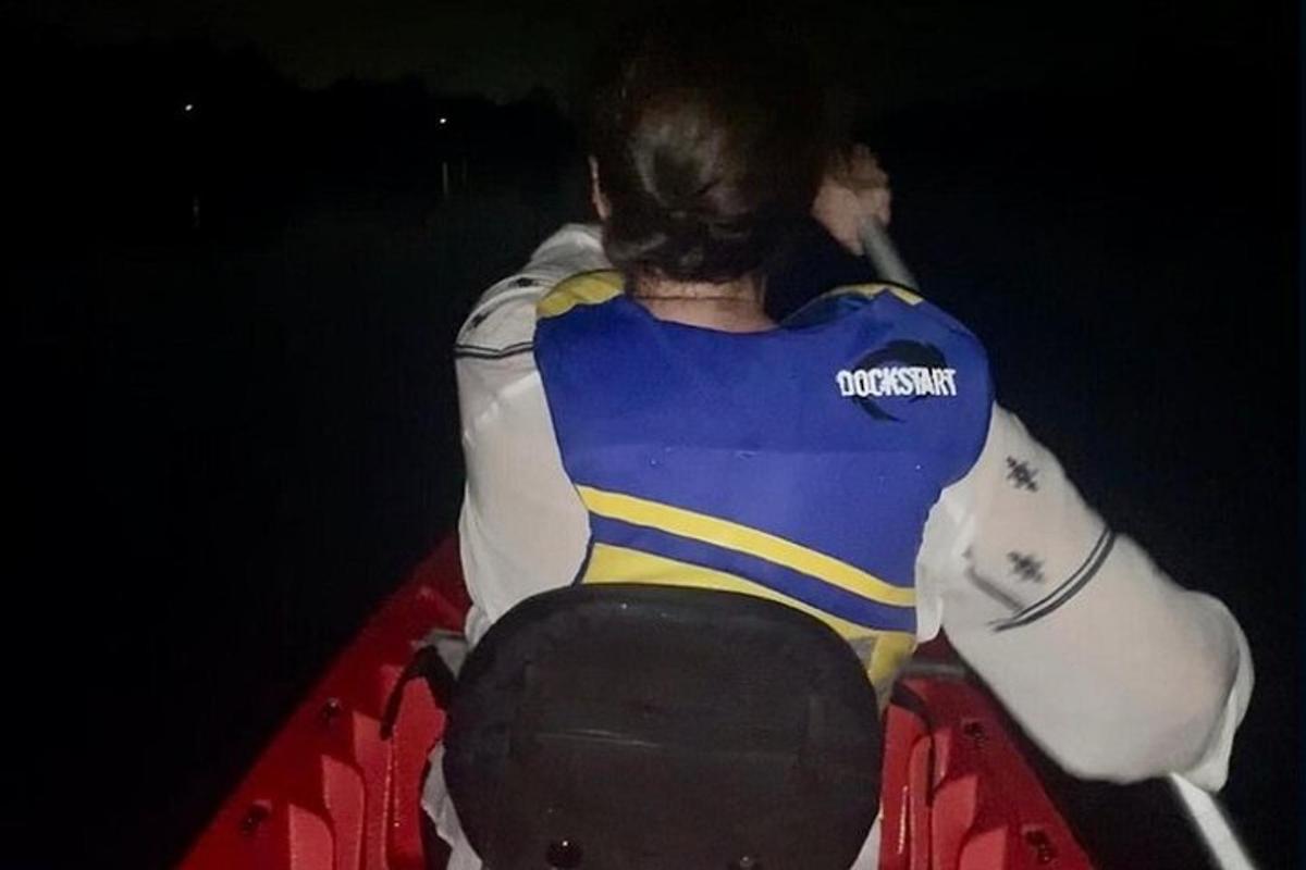 a person is sitting on a surfboard