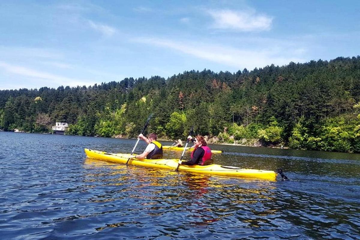 two people in a yellow kayak on a lake