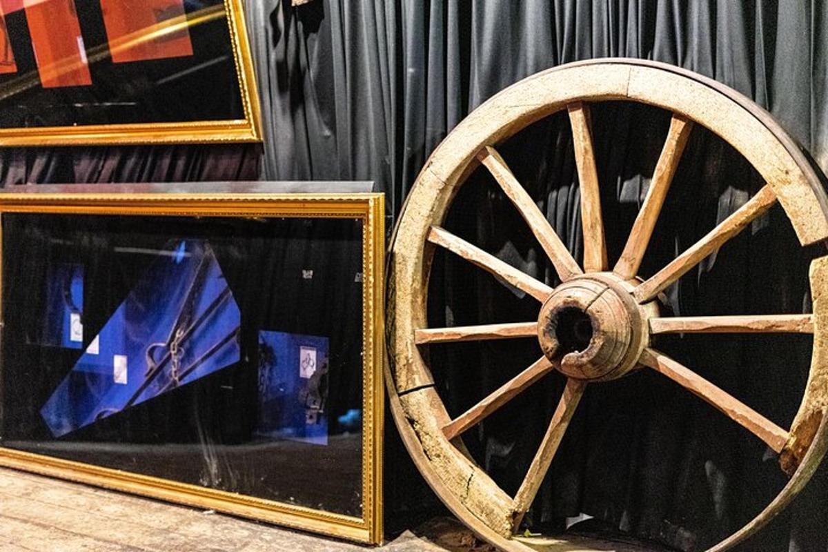 a wooden wagon wheel sitting next to a mirror