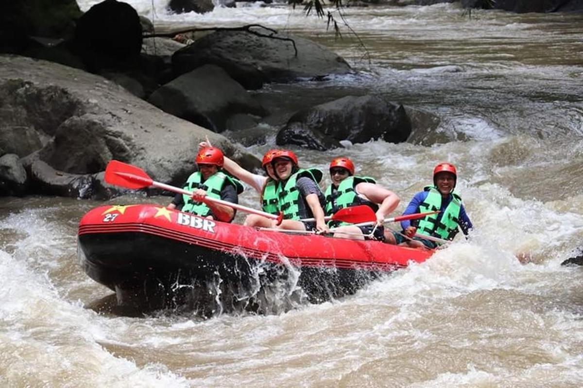 a group of people in a red raft in a river