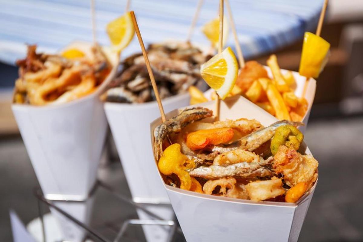 a group of fast food dishes in cones with fries