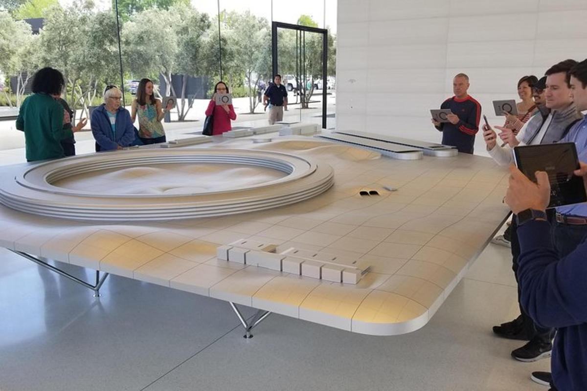 a large table with people standing around it