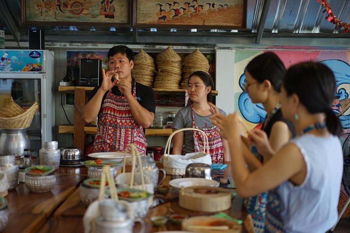 a group of people standing around a table