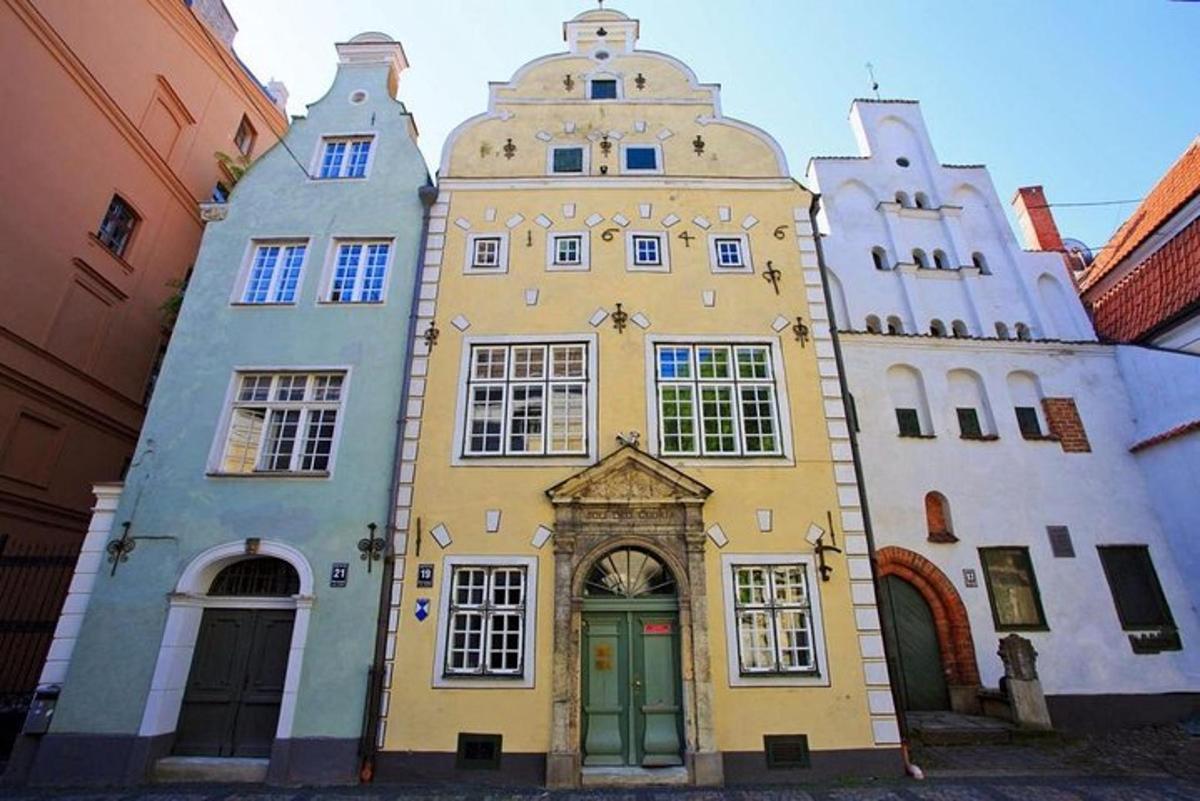 a yellow and white building with a green door
