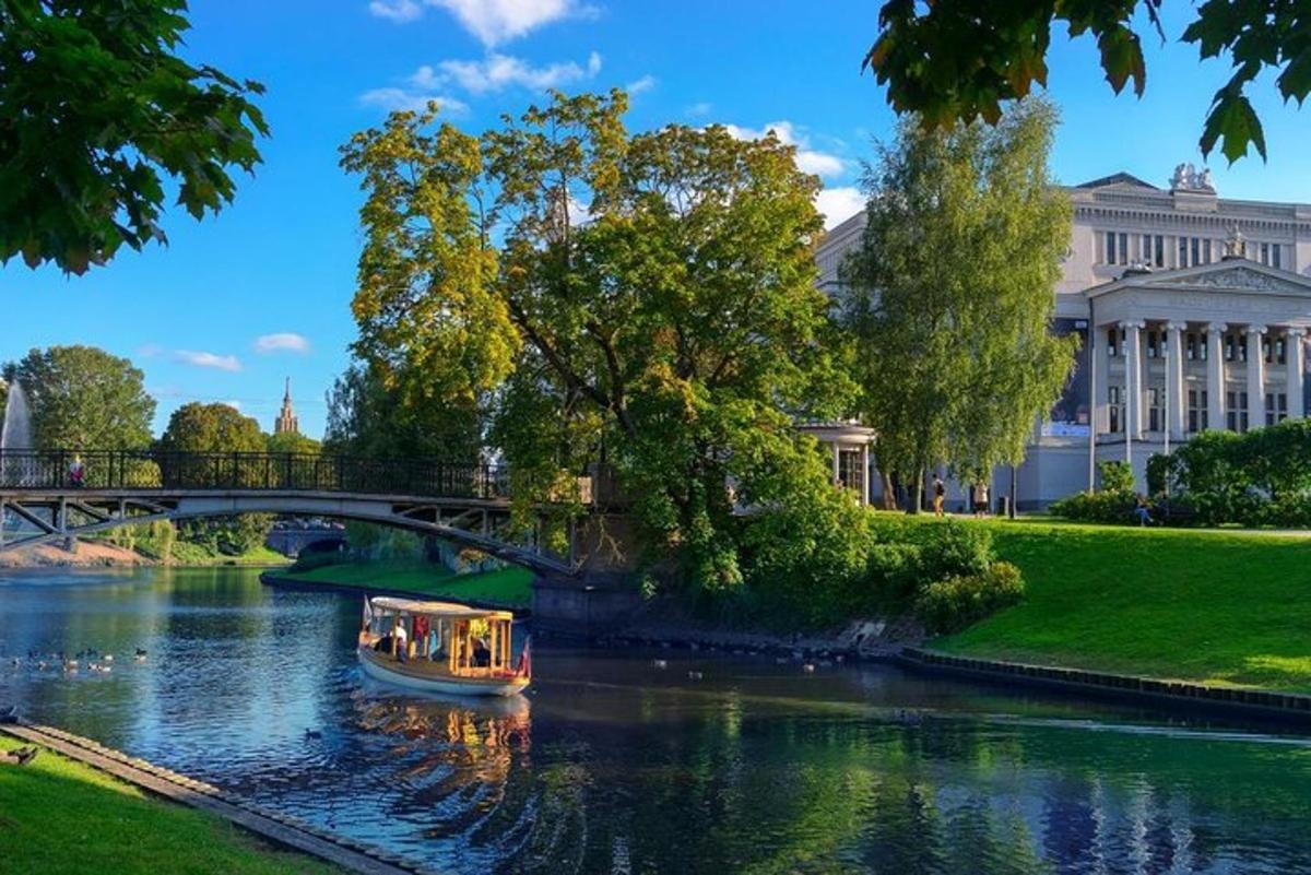 a boat on a river in front of a bridge