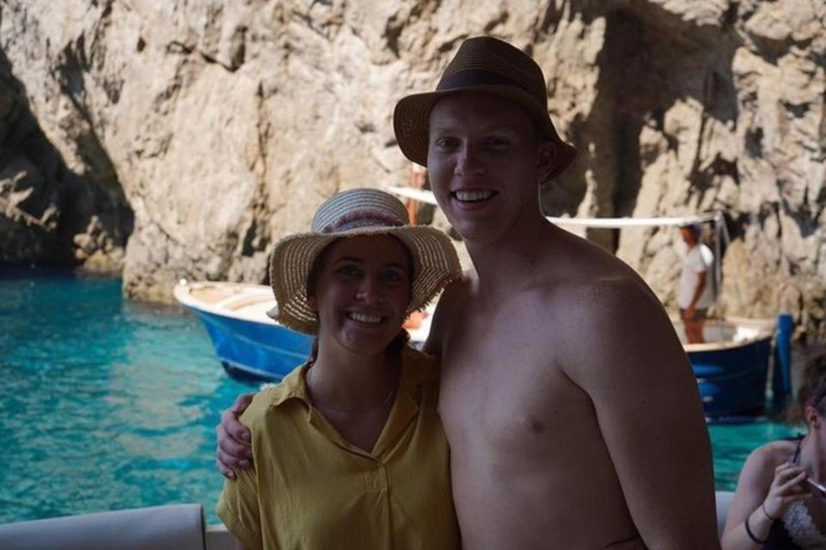 a man and a woman standing on a boat in the water