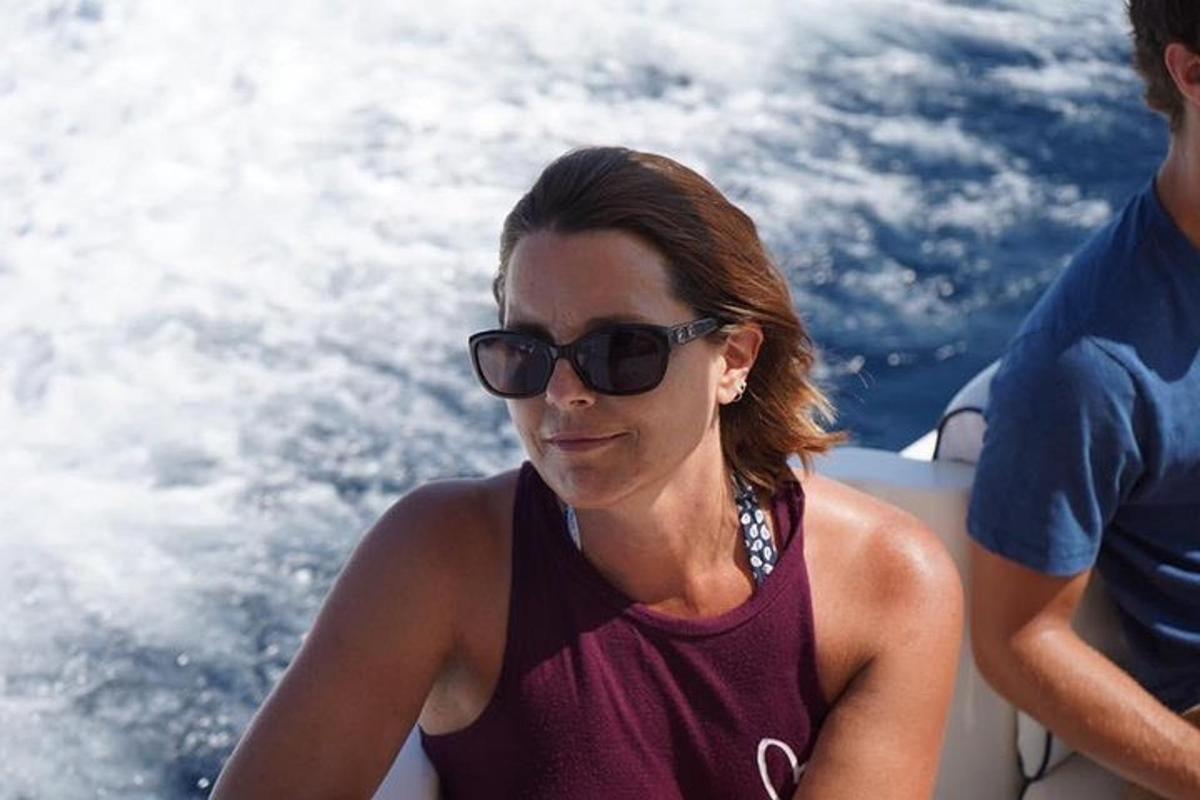 a woman in sunglasses sitting on a boat