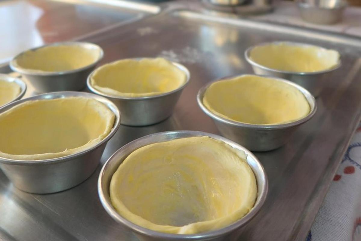 a group of small metal bowls filled with dough