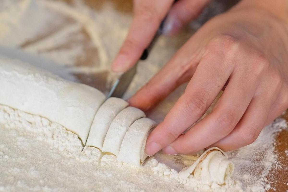 a person is cutting a dough with a knife