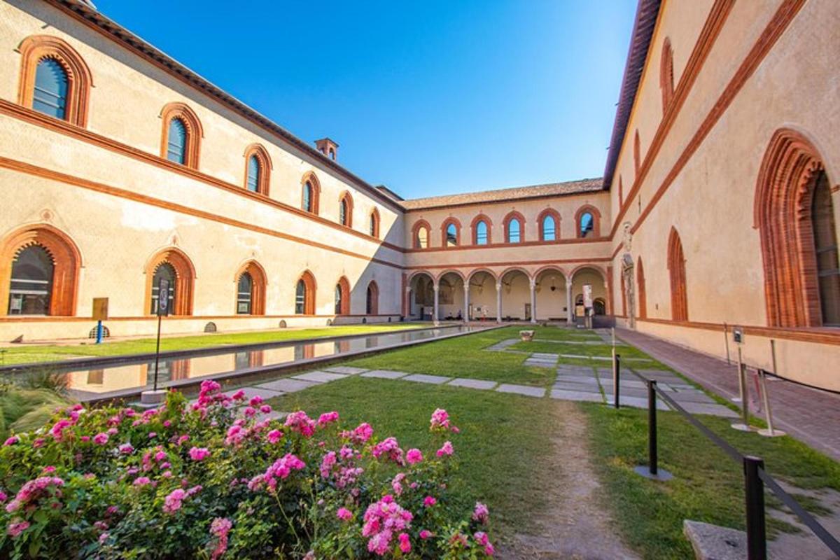 a courtyard of a building with pink flowers