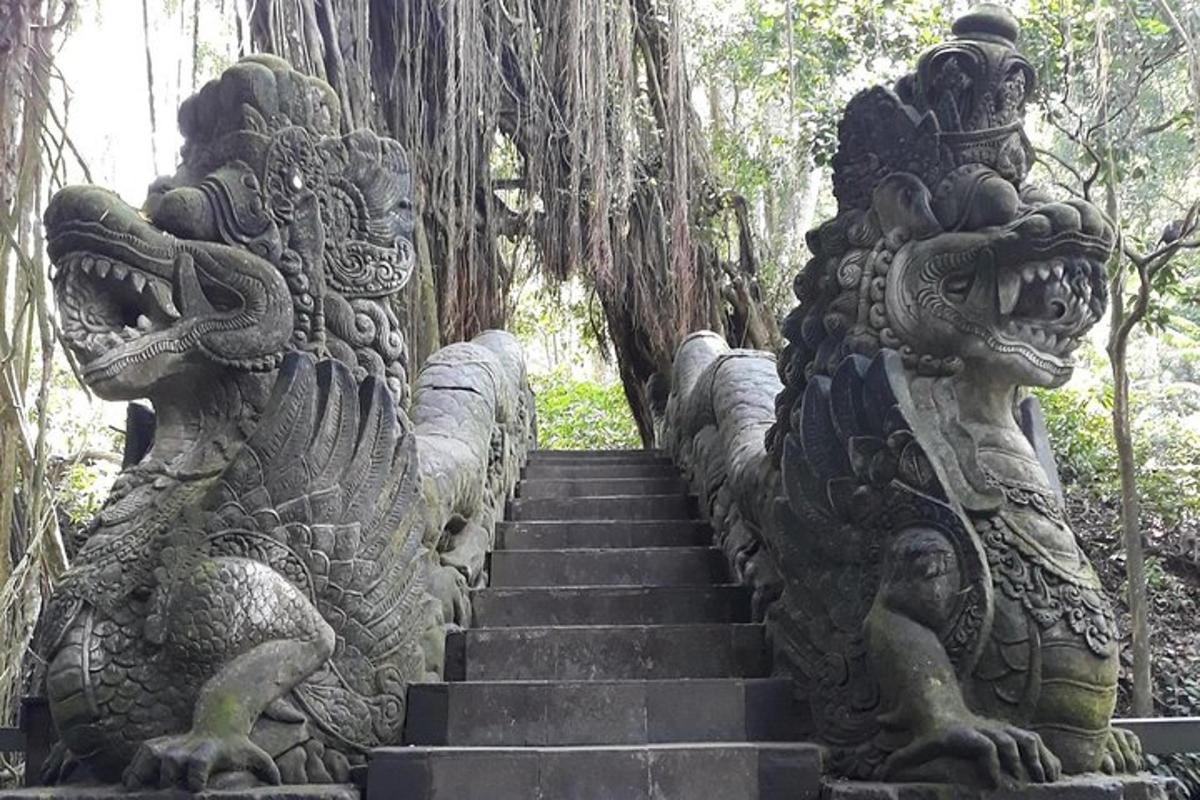 a stairway with stone statues in a forest
