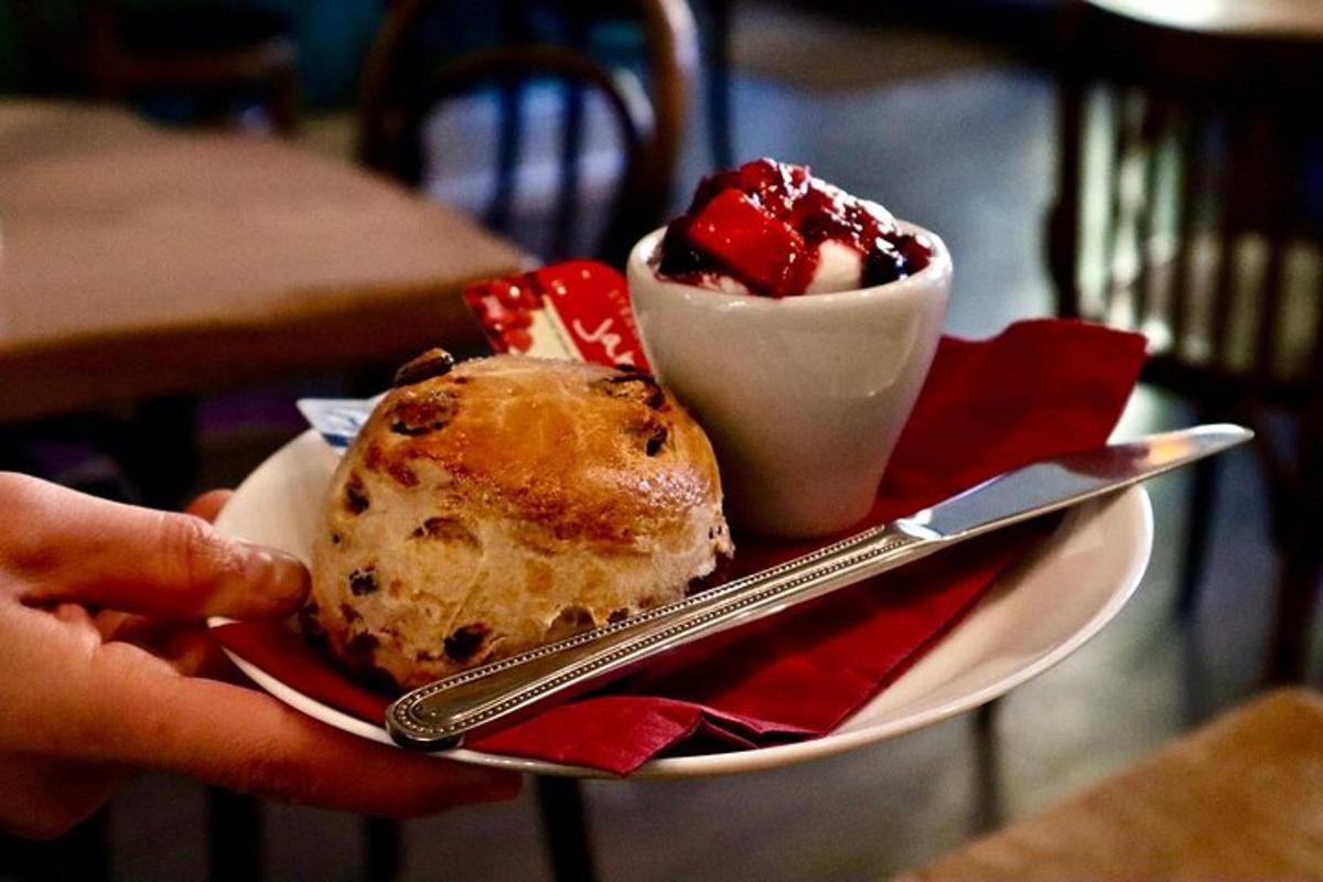 a person holding a plate of food with a dessert