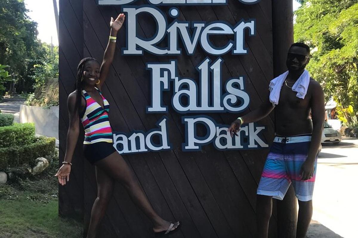a couple of people standing in front of a sign