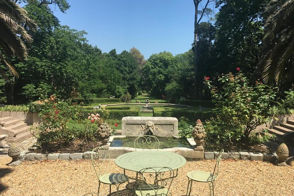 un tavolo e delle sedie in un giardino con una fontana