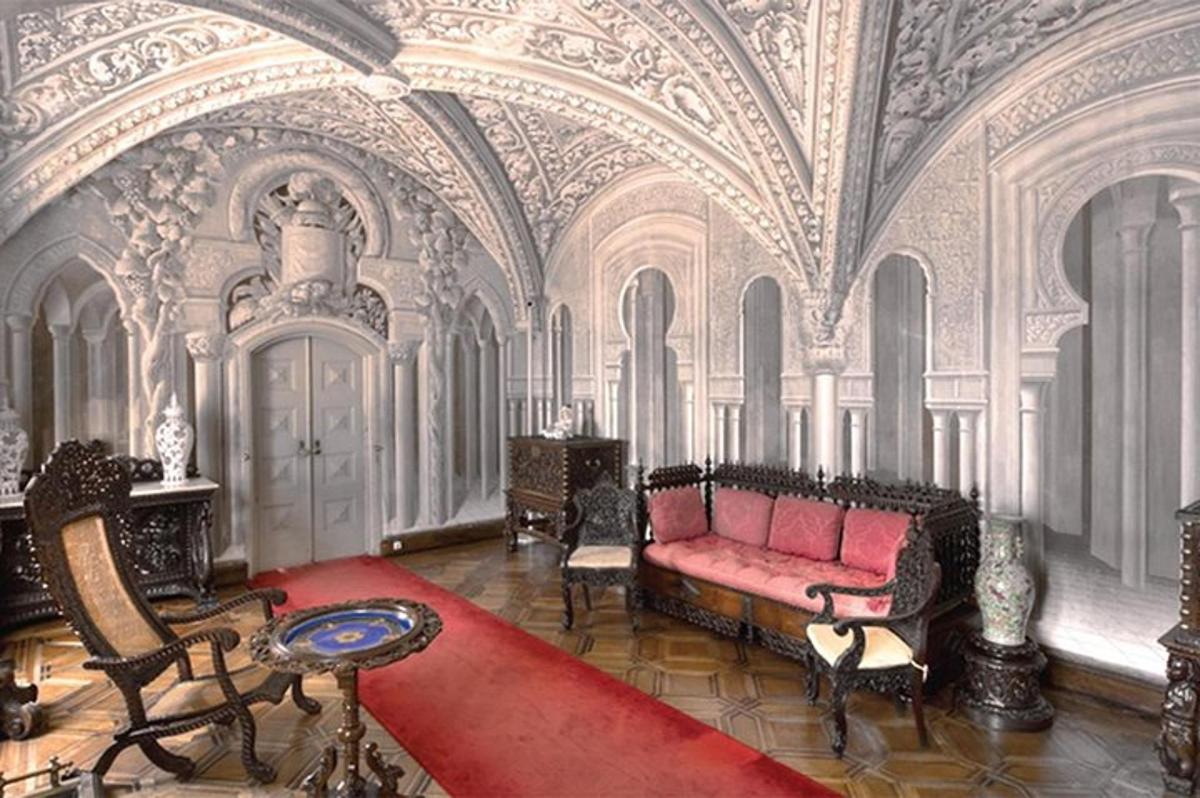 a living room with a red couch and a red carpet