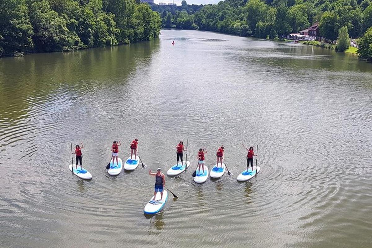 en gruppe mennesker på paddleboards på en flod