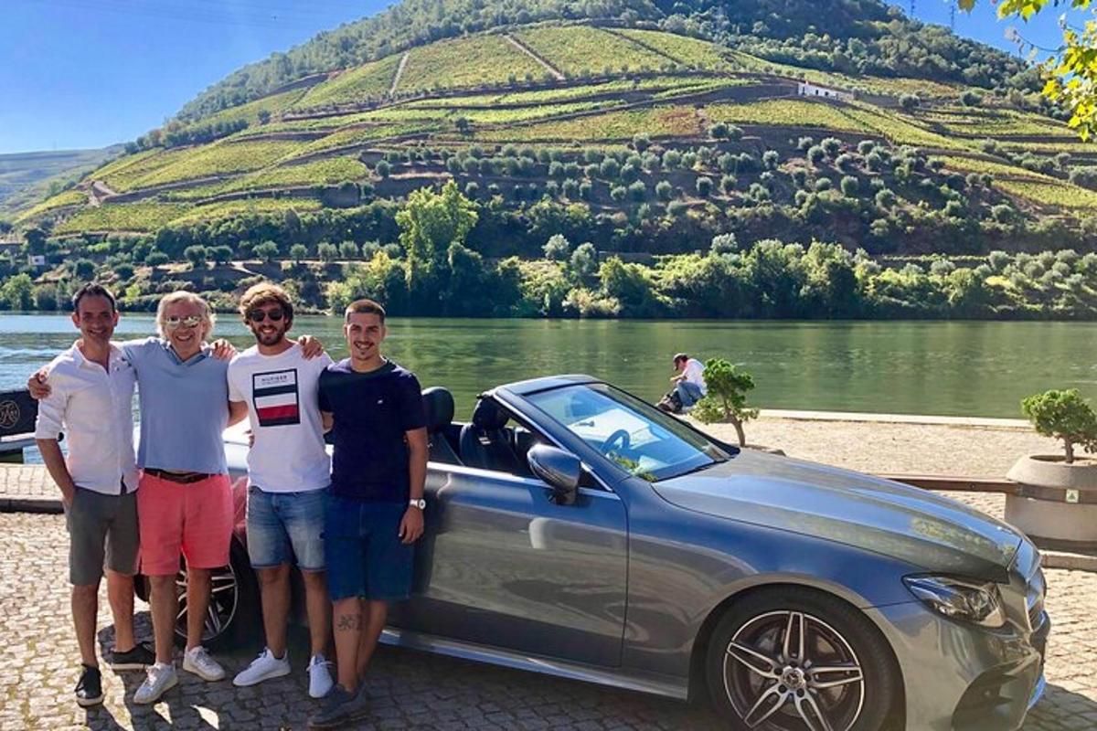 a group of people standing in front of a car