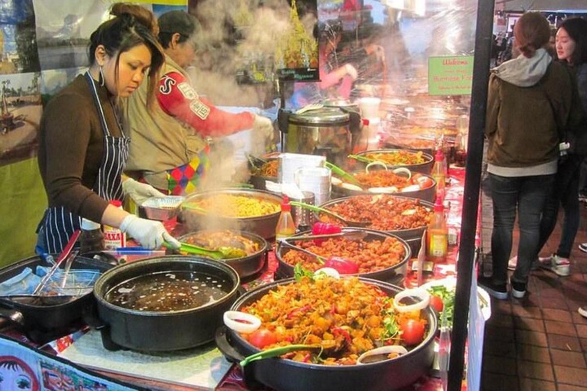 a group of people preparing food in pots on a buffet
