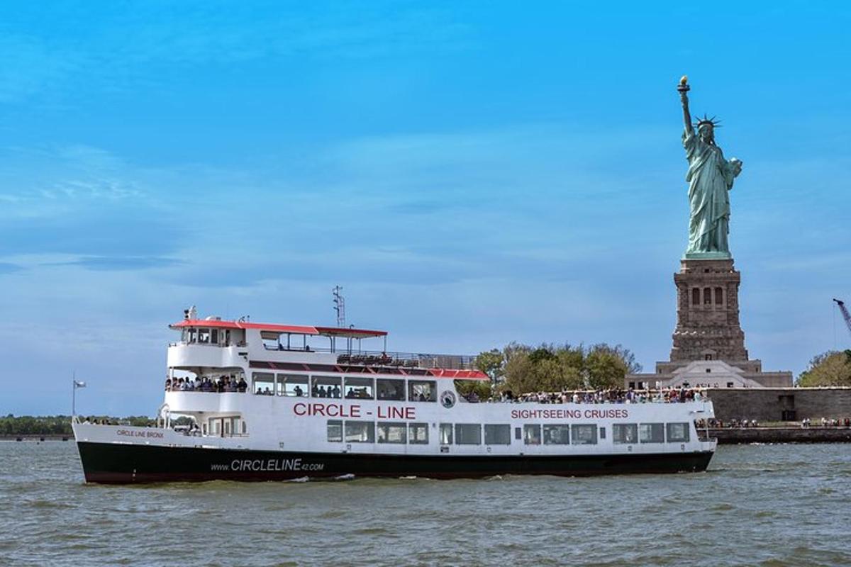 a cruise ship in front of the statue of liberty