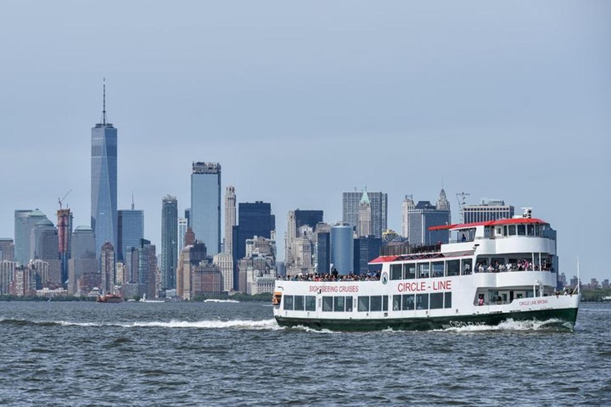 a ferry boat on the water with a city in the background