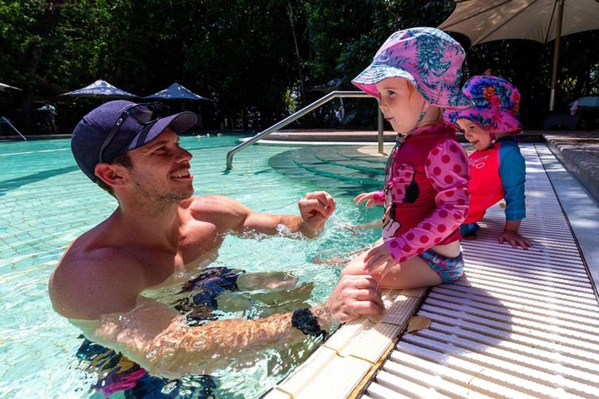 a man and a little girl in a swimming pool