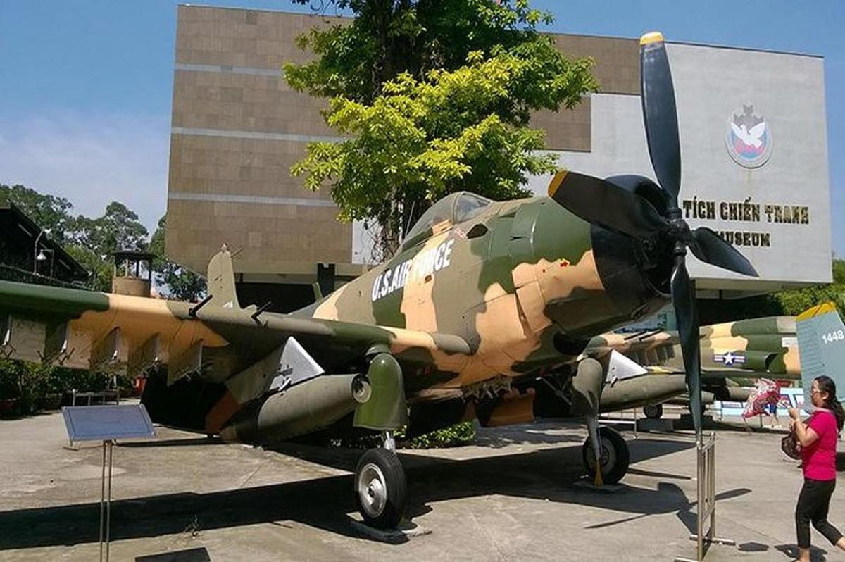 a military plane on display in front of a building
