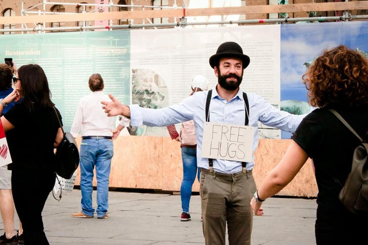 a man with a sign that says free hugs