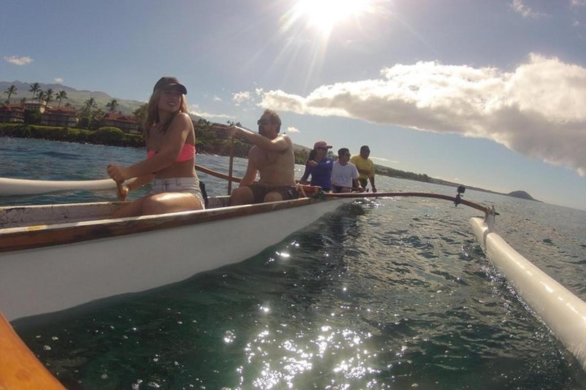a group of people sitting on a boat in the water