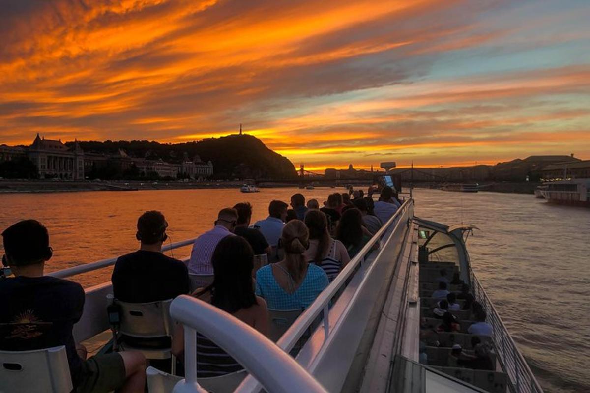 a group of people on a boat at sunset
