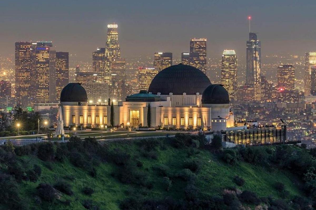 a large building in front of a city at night