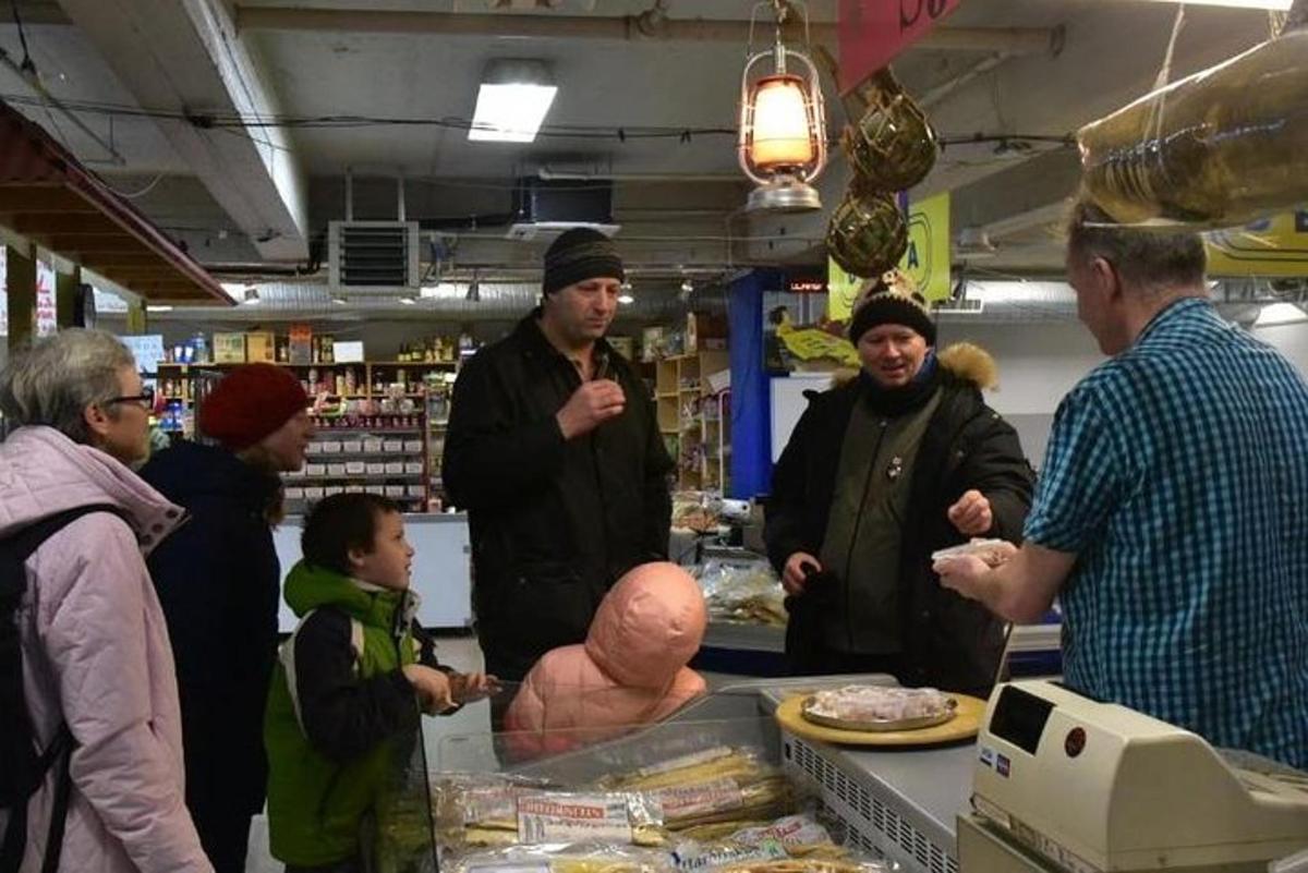 a group of people standing around a store with a dummy