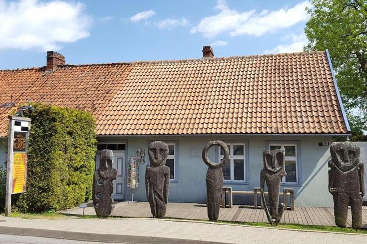 a house with statues of people in front of it