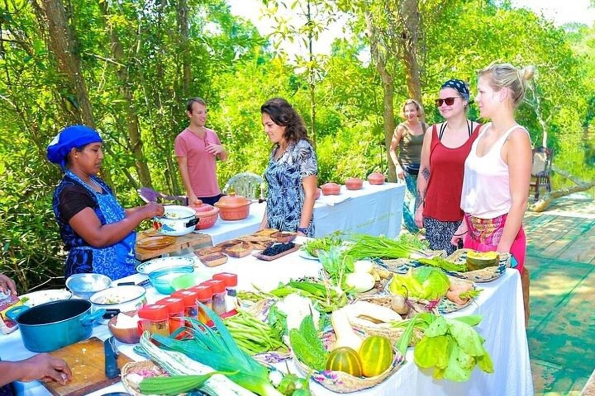 a group of people standing around a table full of food