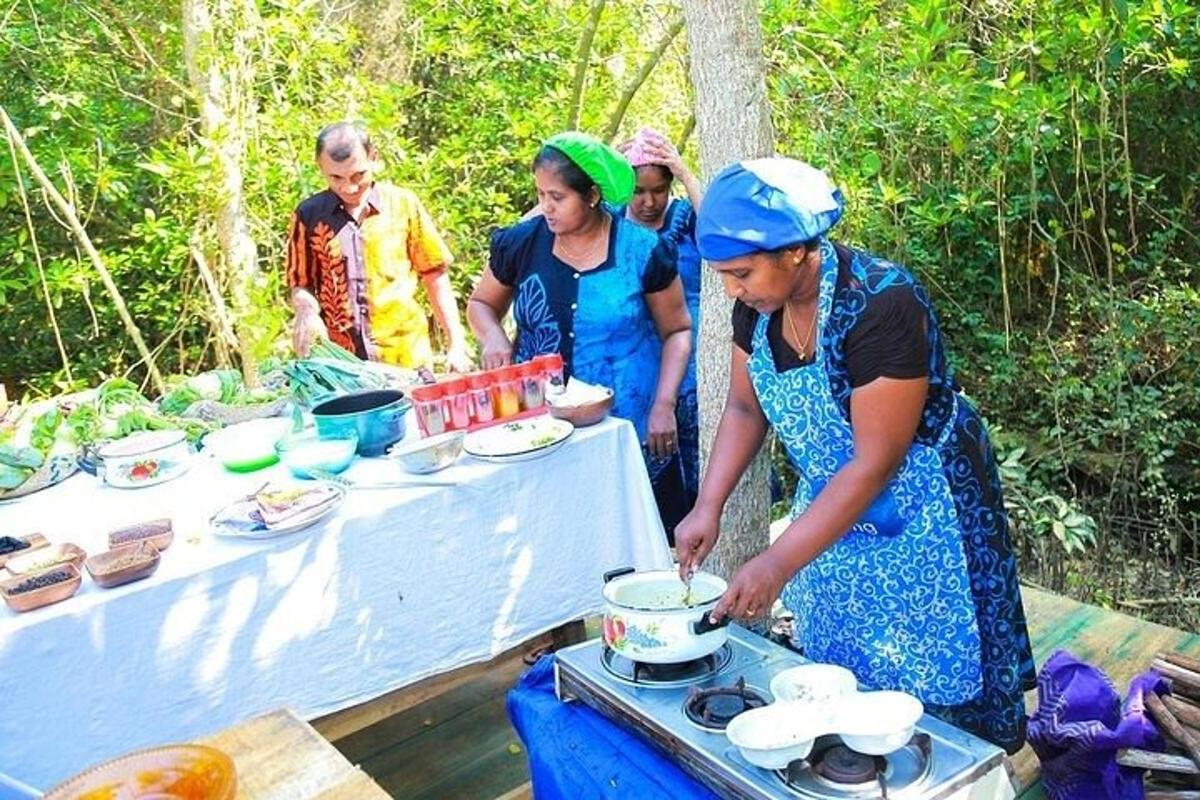 a group of people standing around a table preparing food