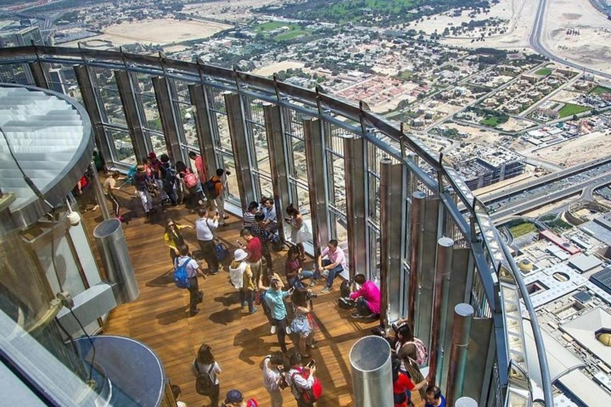 a group of people standing in a building looking at a city