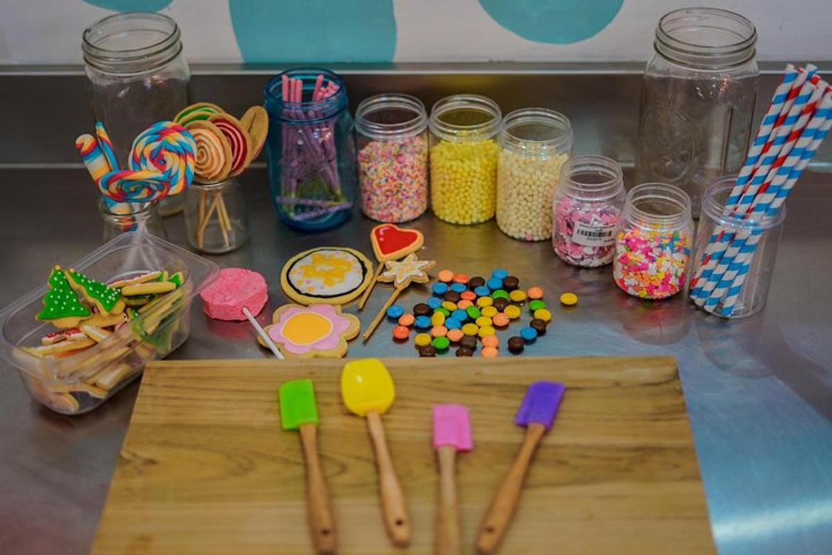 une table surmontée d'ustensiles en bois et de pots de bonbons