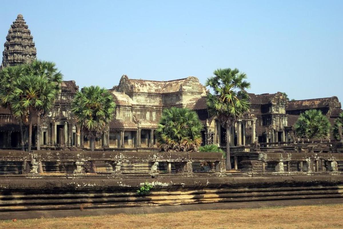 a large building with palm trees in front of it