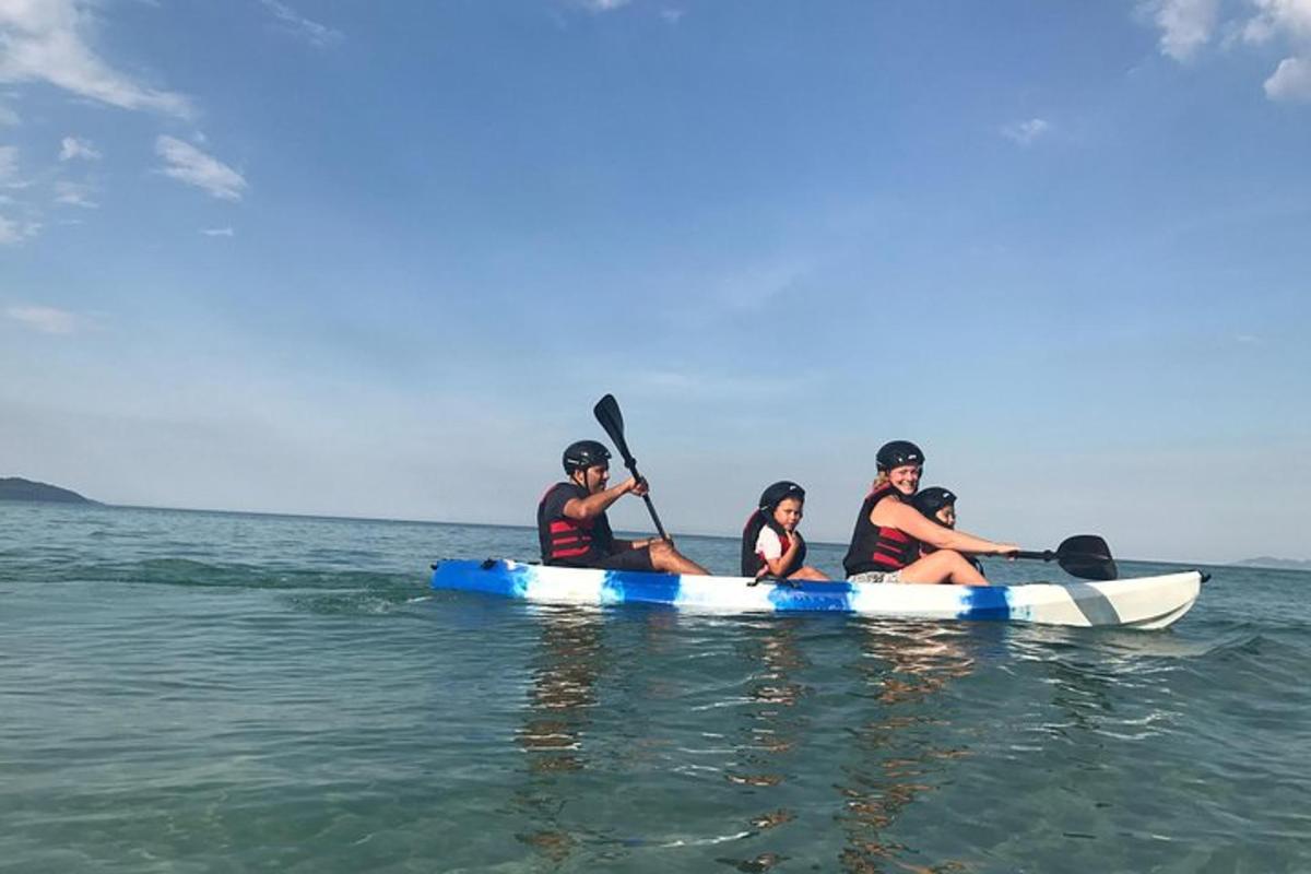 a group of people sitting on a kayak in the water